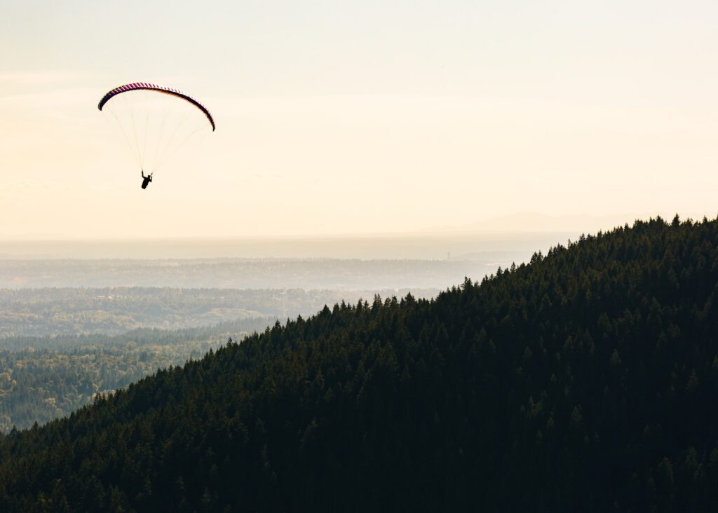 person paragliding near mountain